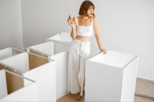 Young woman assembling fitted wardrobes